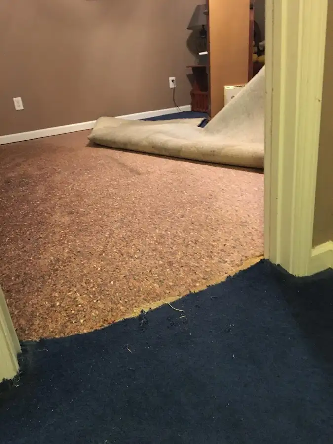 Carpet pad removal revealing water damage during Water Mitigation Services in Cottonwood
